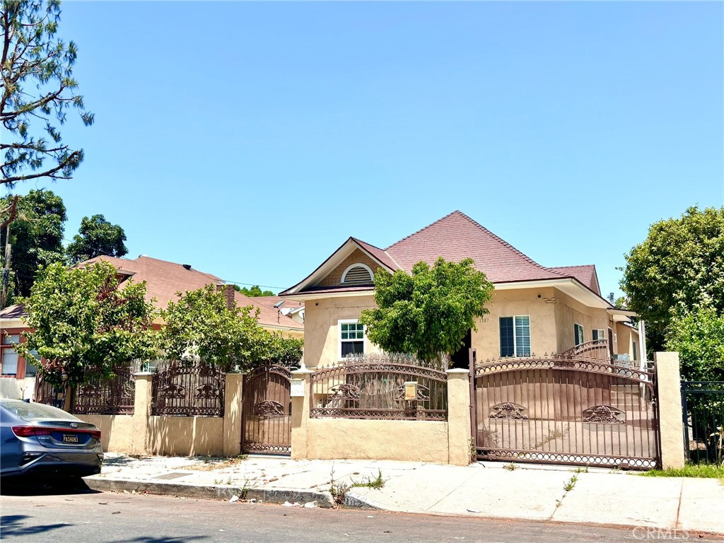 a front view of a house with a garden