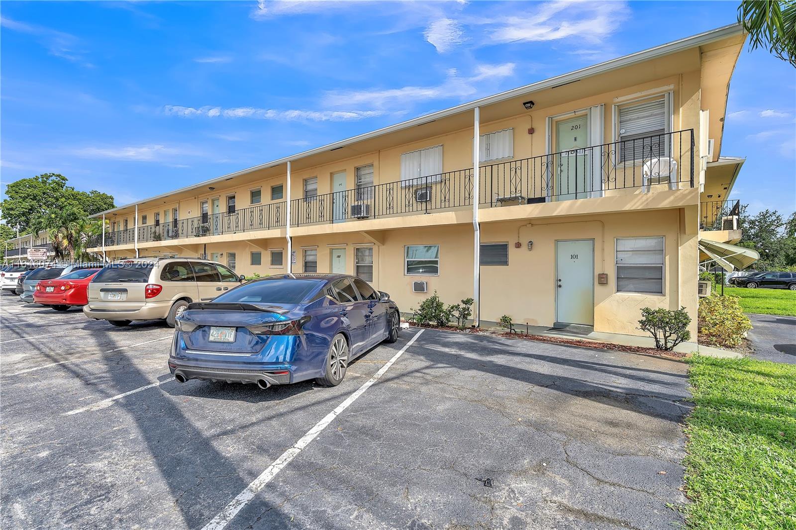 a front view of a house with cars parked