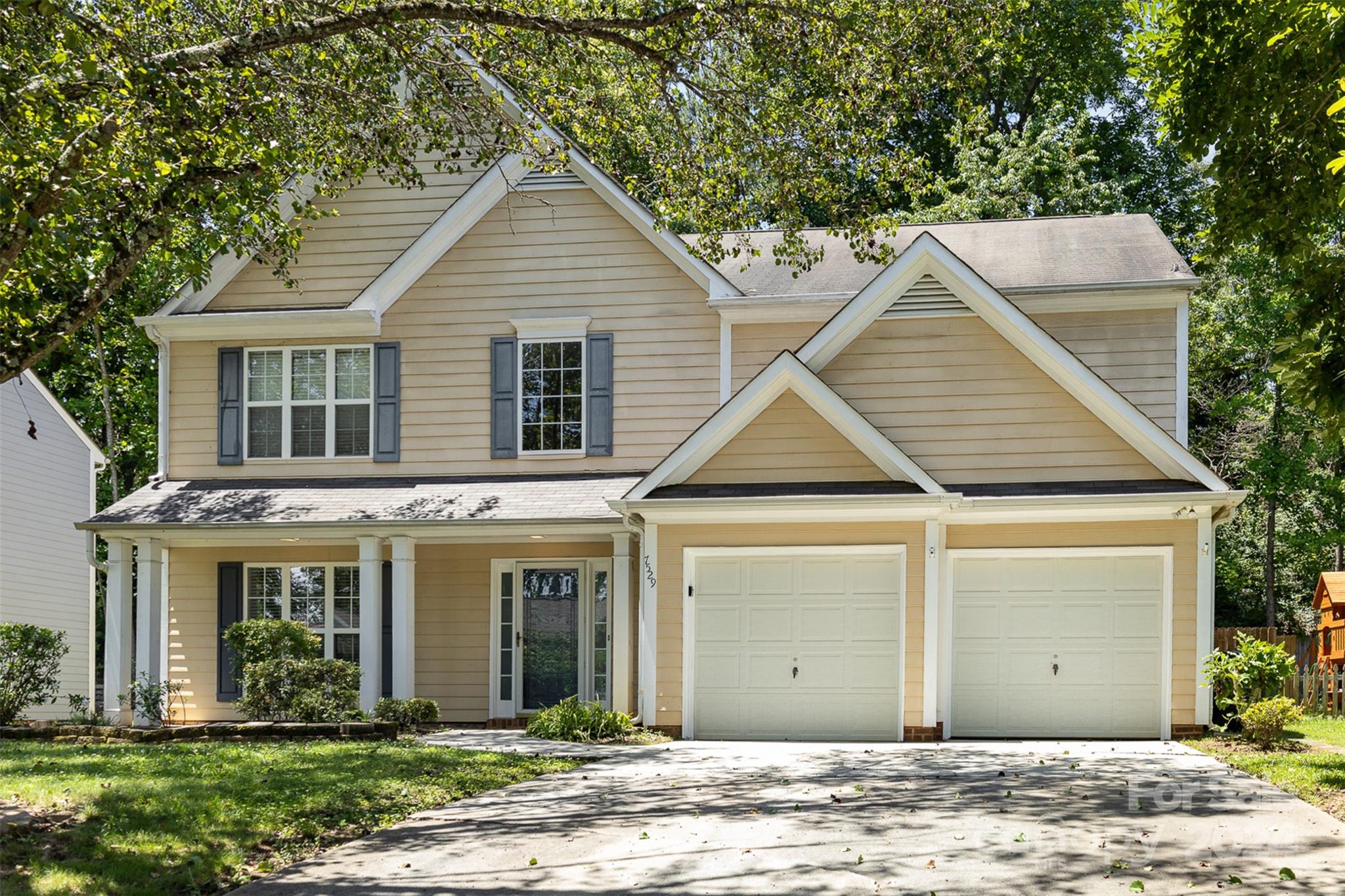 a front view of a house with a yard and porch