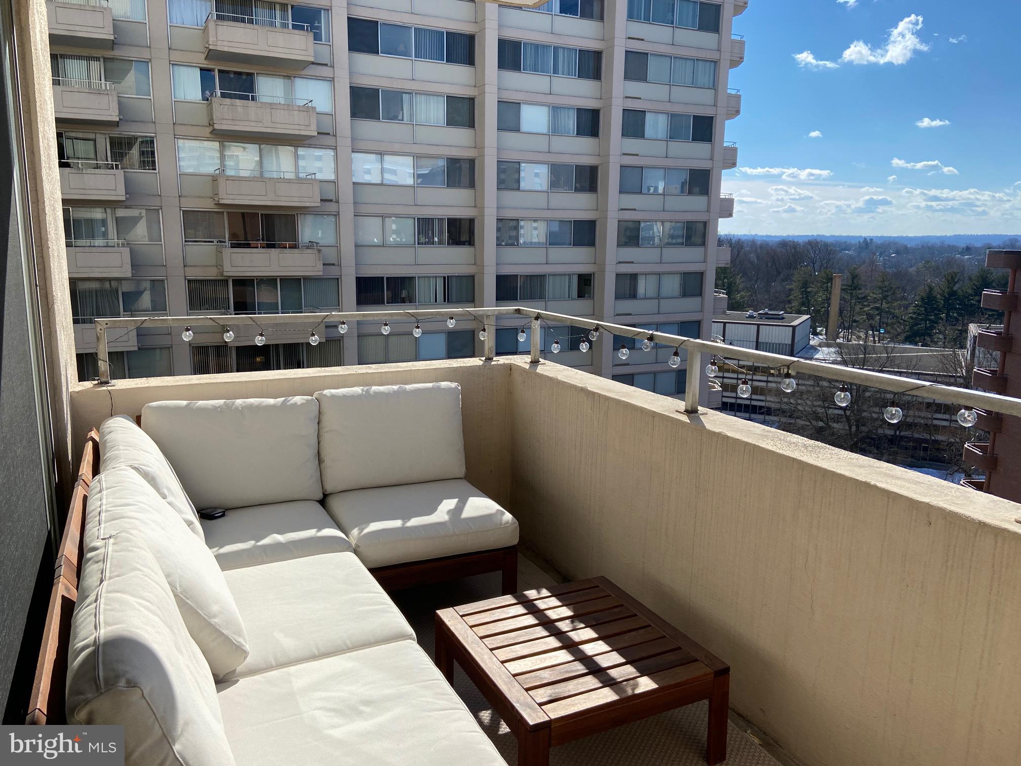 a view of a balcony with a couch and wooden floor