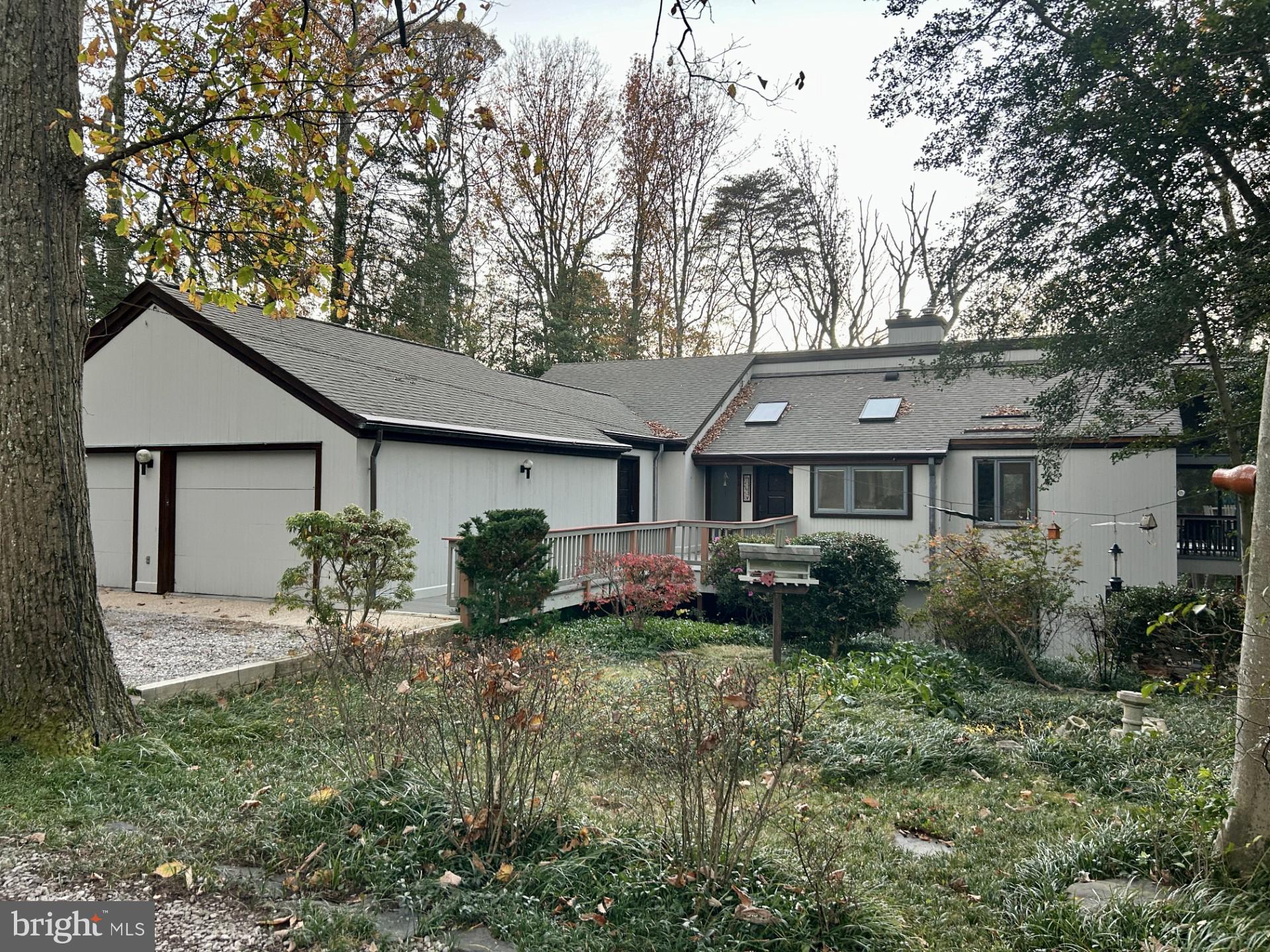 a front view of house with yard and trees