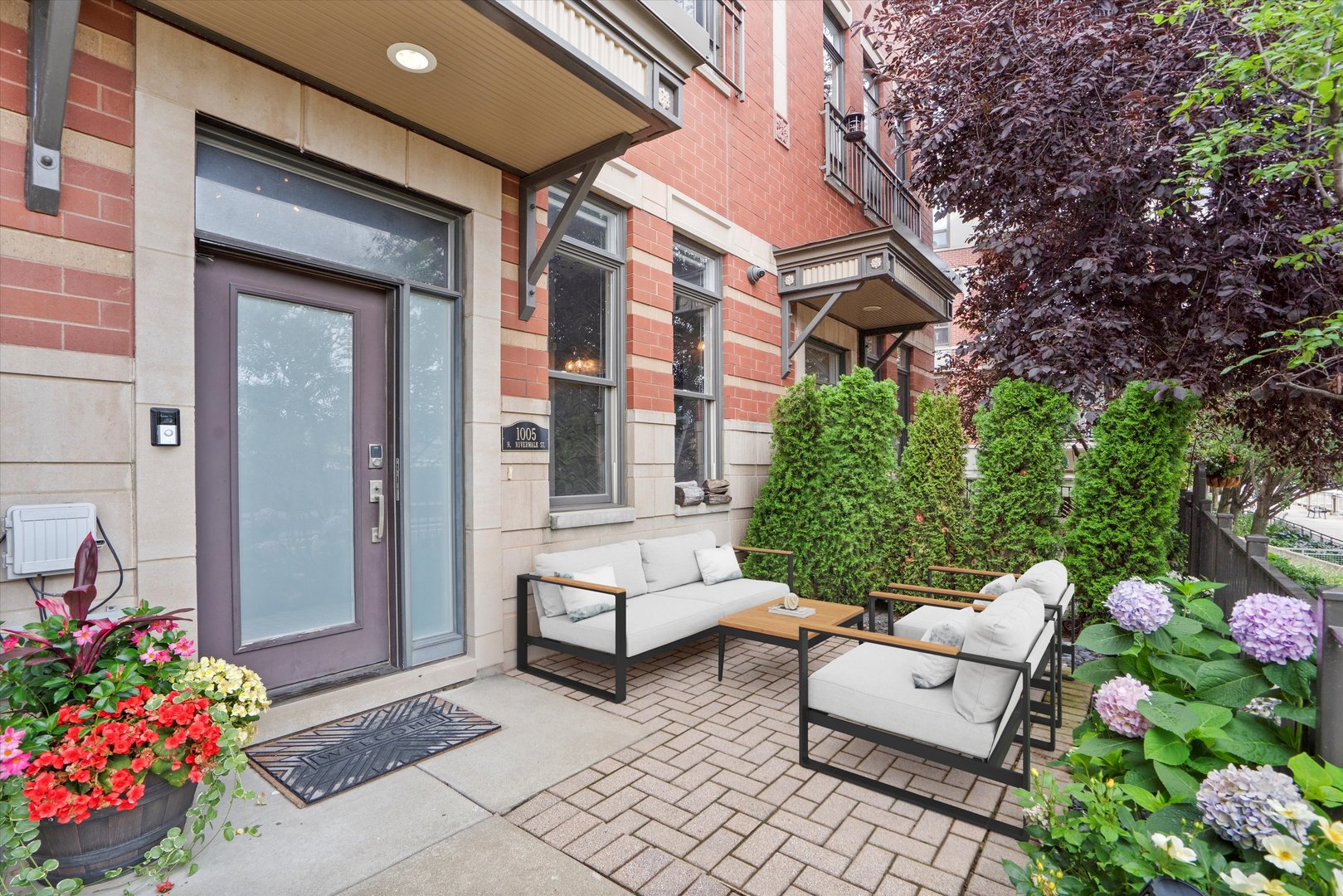 a view of a chair and tables in the patio front of house