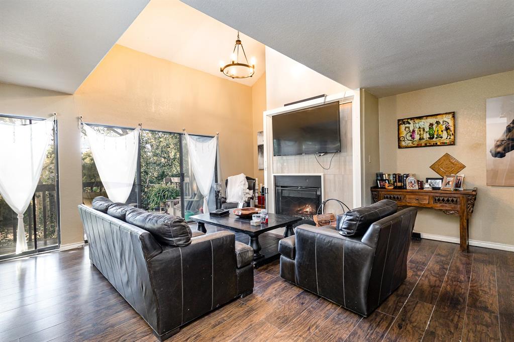 a living room with furniture fireplace and a flat screen tv