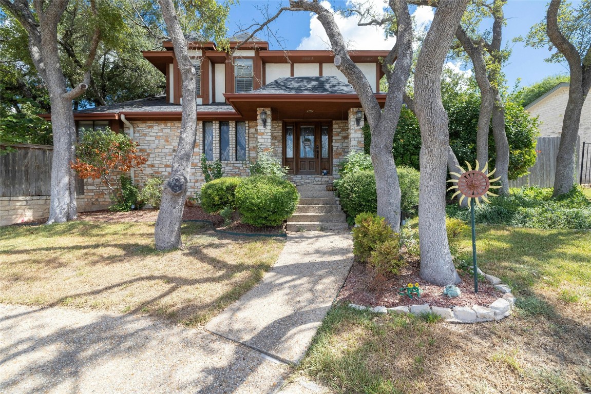 a front view of a house with garden