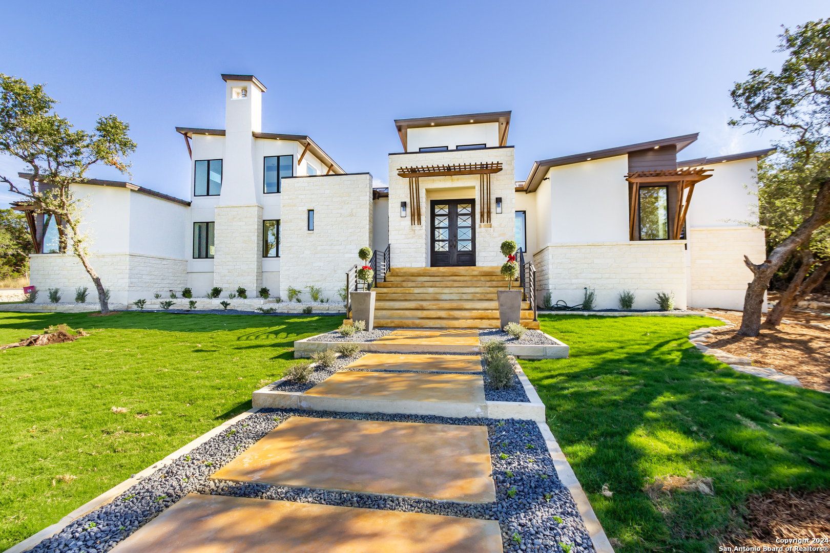 a front view of a house with garden