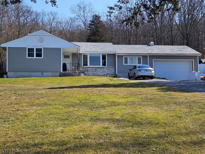 a front view of a house with swimming pool having outdoor seating