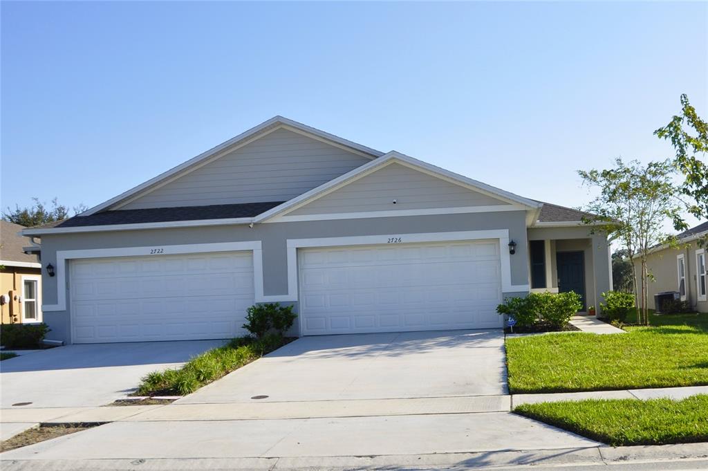 a front view of a house with garage