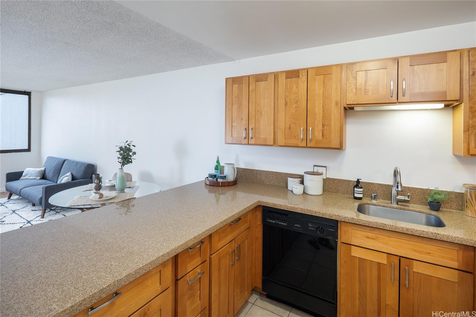 a kitchen with stainless steel appliances granite countertop a sink dishwasher stove and cabinets with wooden floor