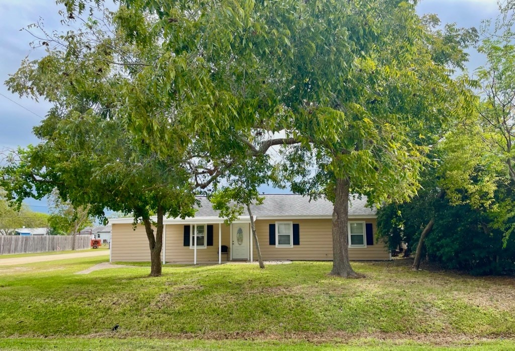 a front view of a house with a garden