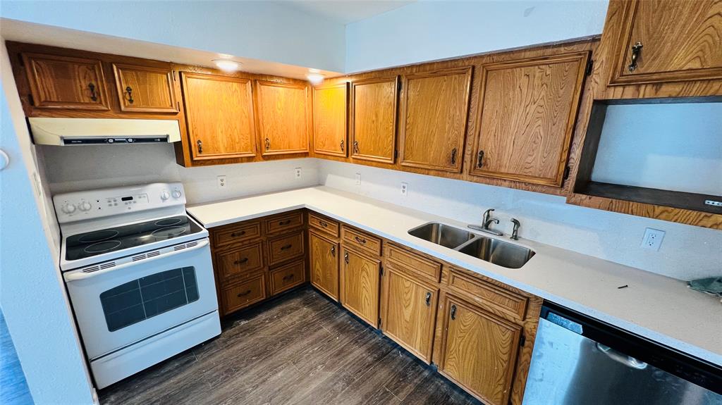 a kitchen with stainless steel appliances granite countertop a sink a stove and a microwave