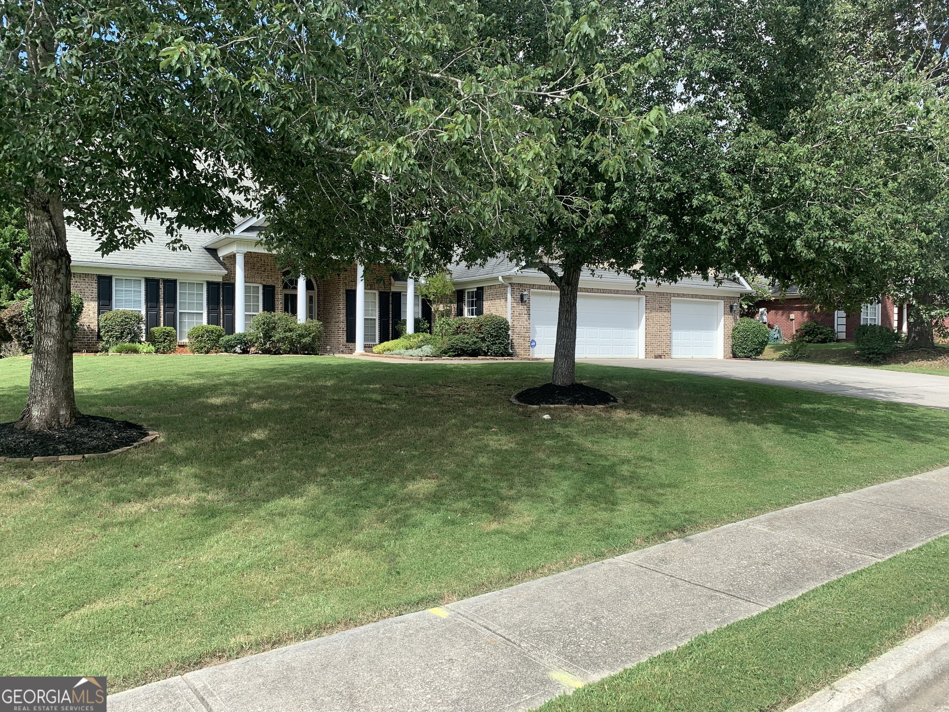 a front view of a house with a yard