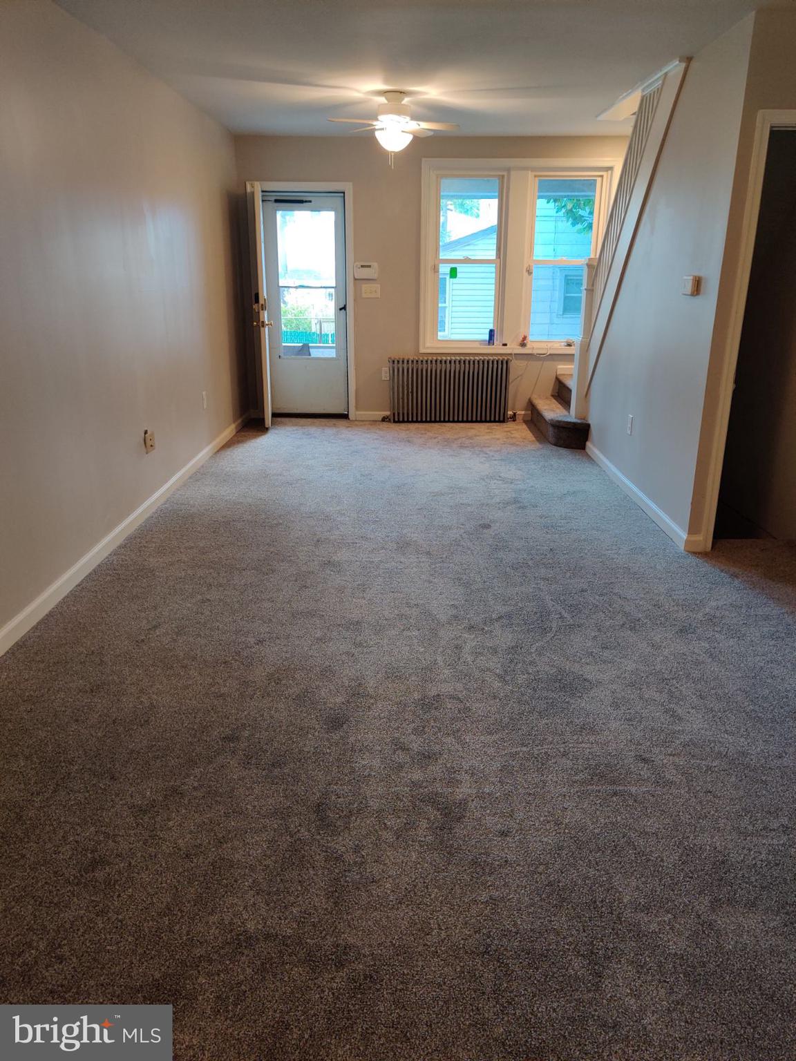 a view of an empty room with a fireplace