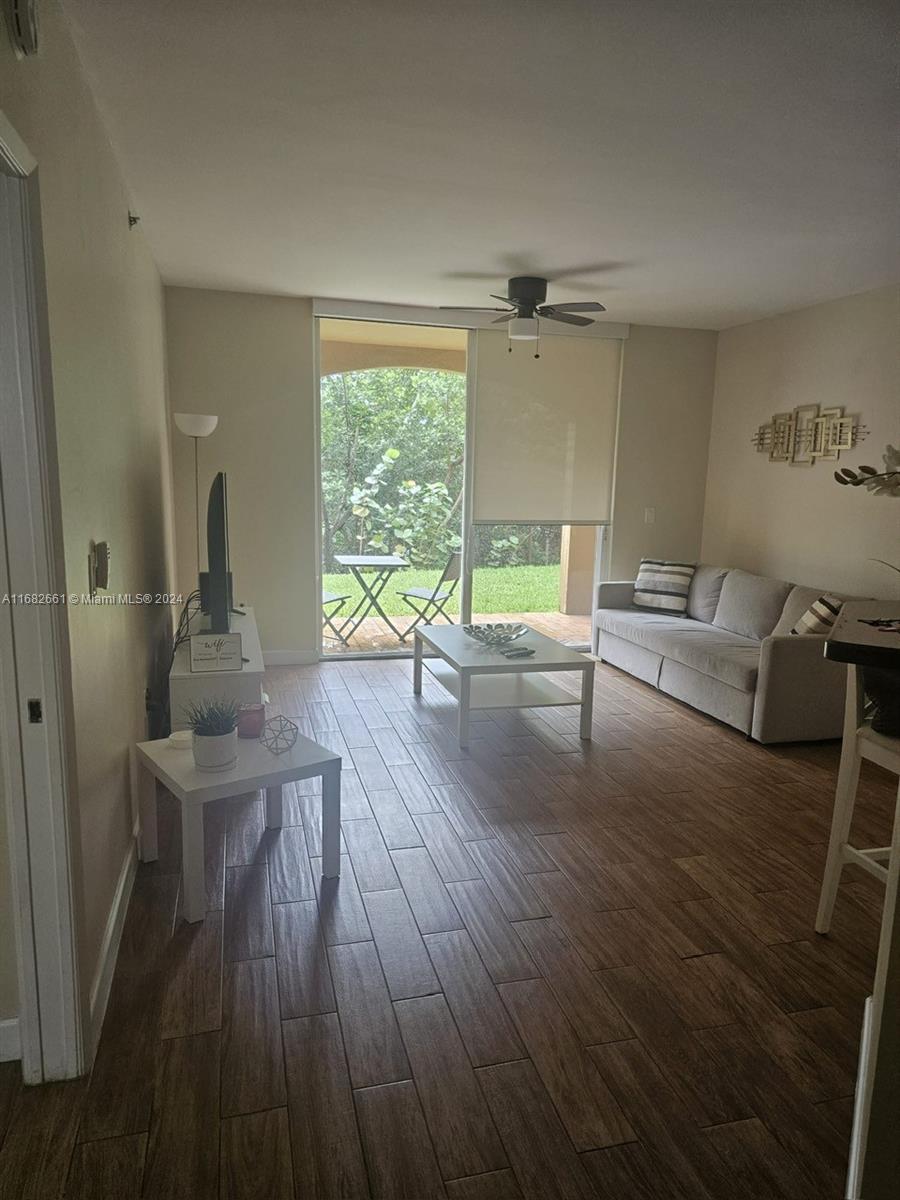 a living room with furniture and a wooden floor