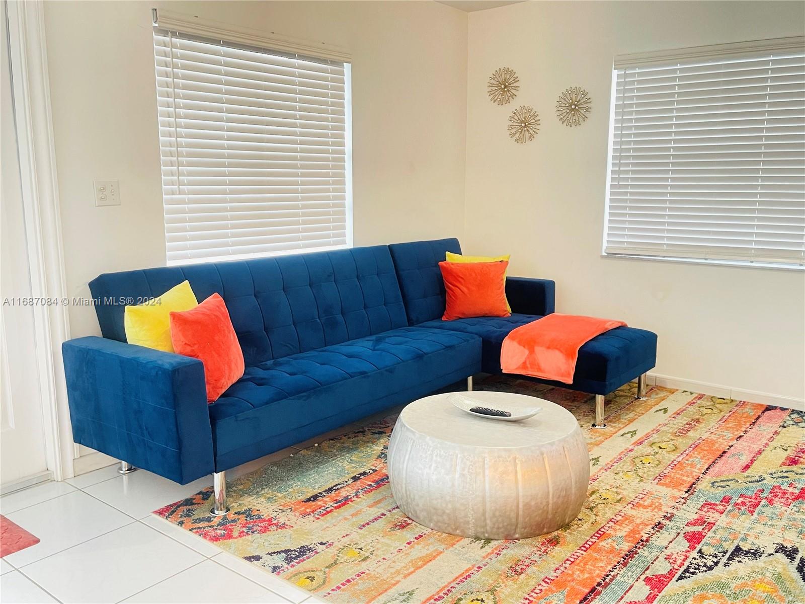 a living room with furniture and a window