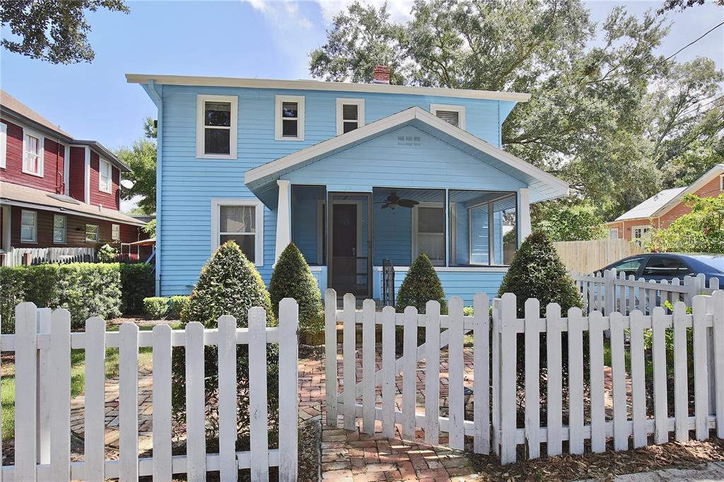 a front view of house with white fence