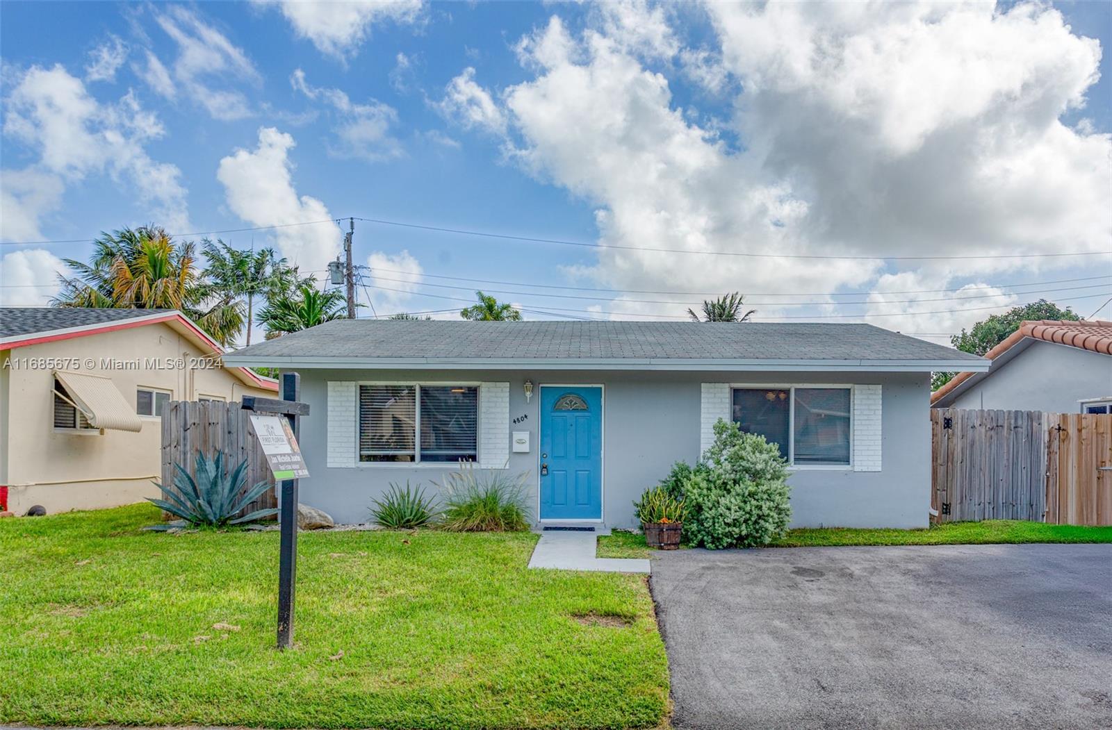 a view of a house with a yard and plants