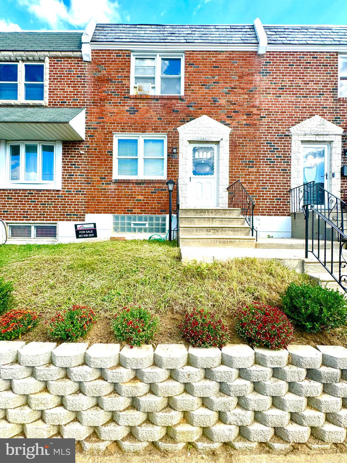 a view of a brick house with a yard