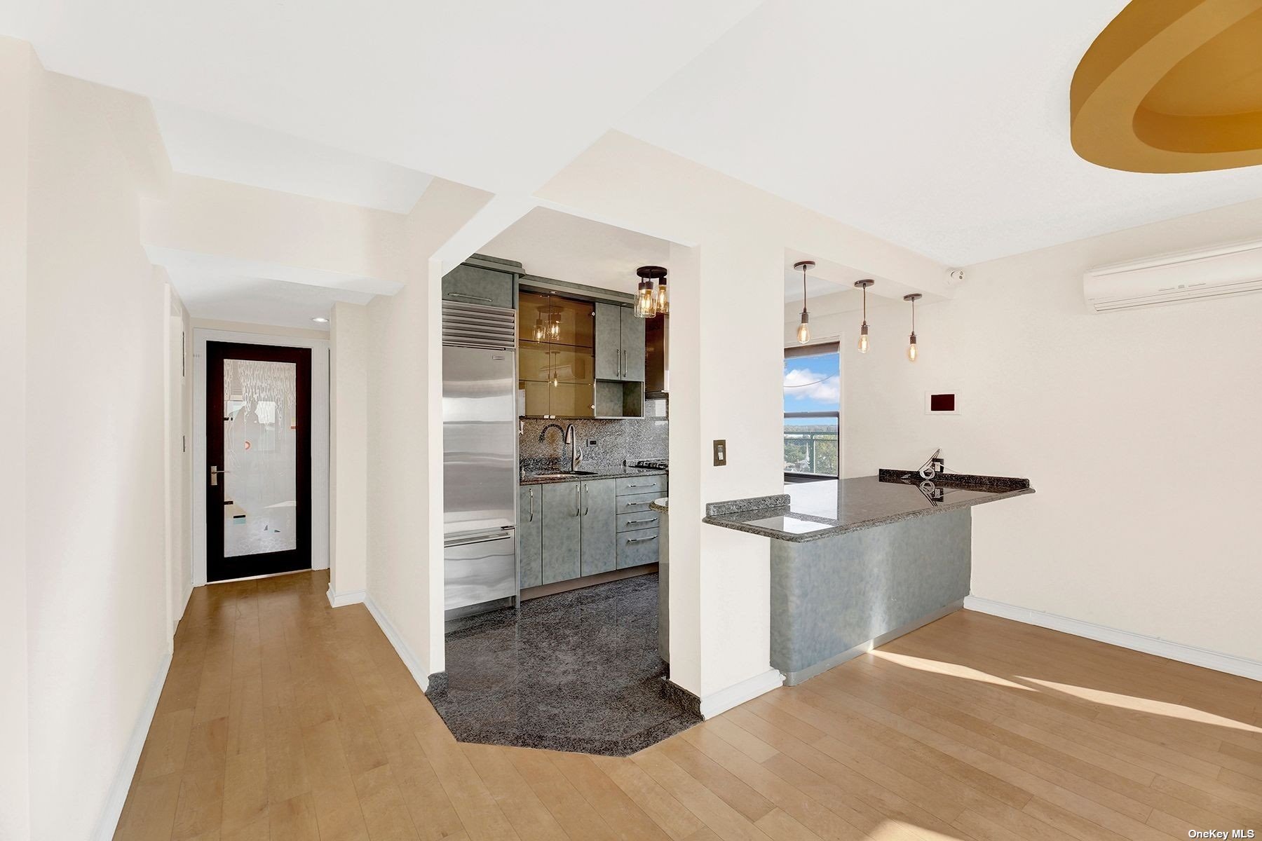 a view of a kitchen with refrigerator and cabinets