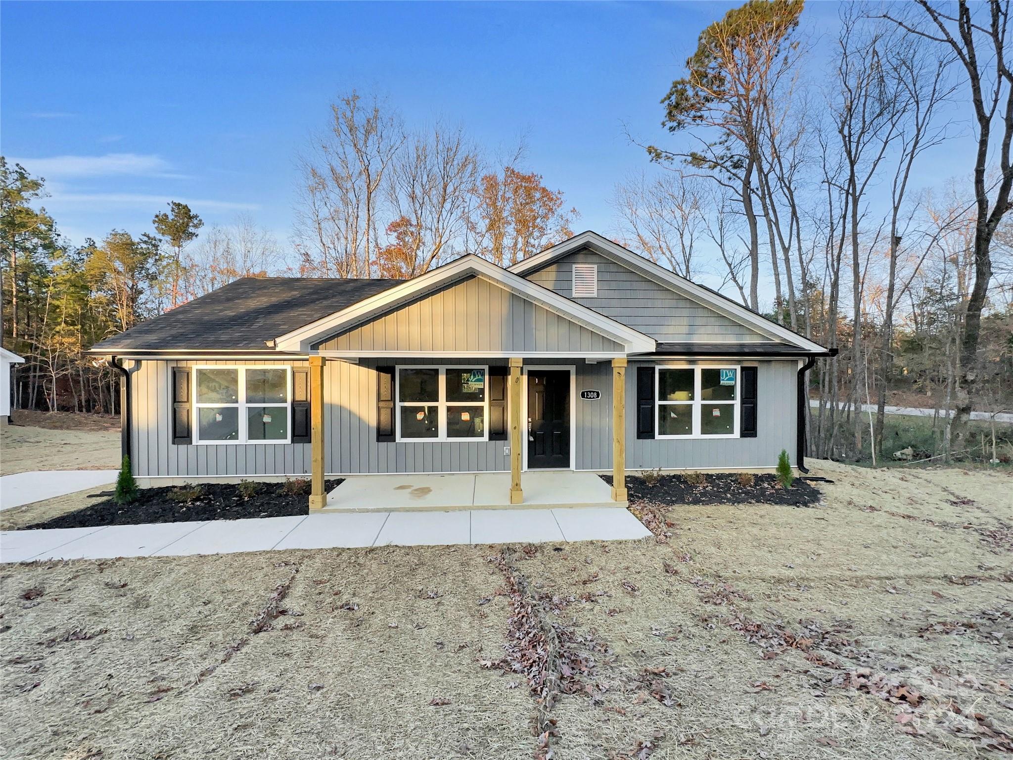 a front view of a house with a yard covered with snow in the yard