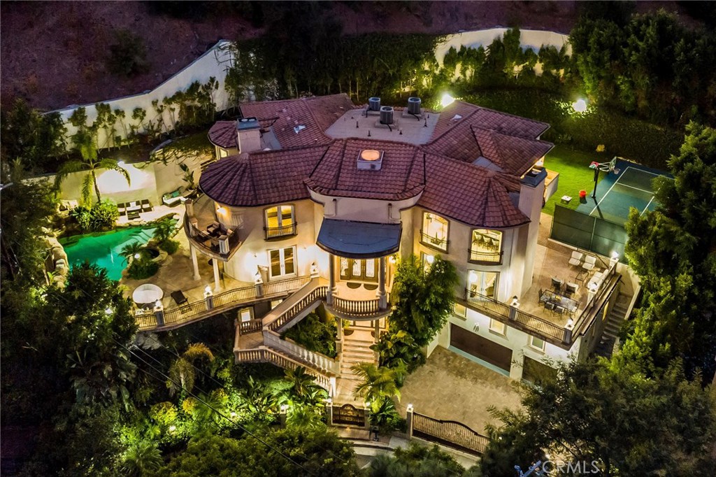 an aerial view of a house with yard swimming pool and outdoor seating