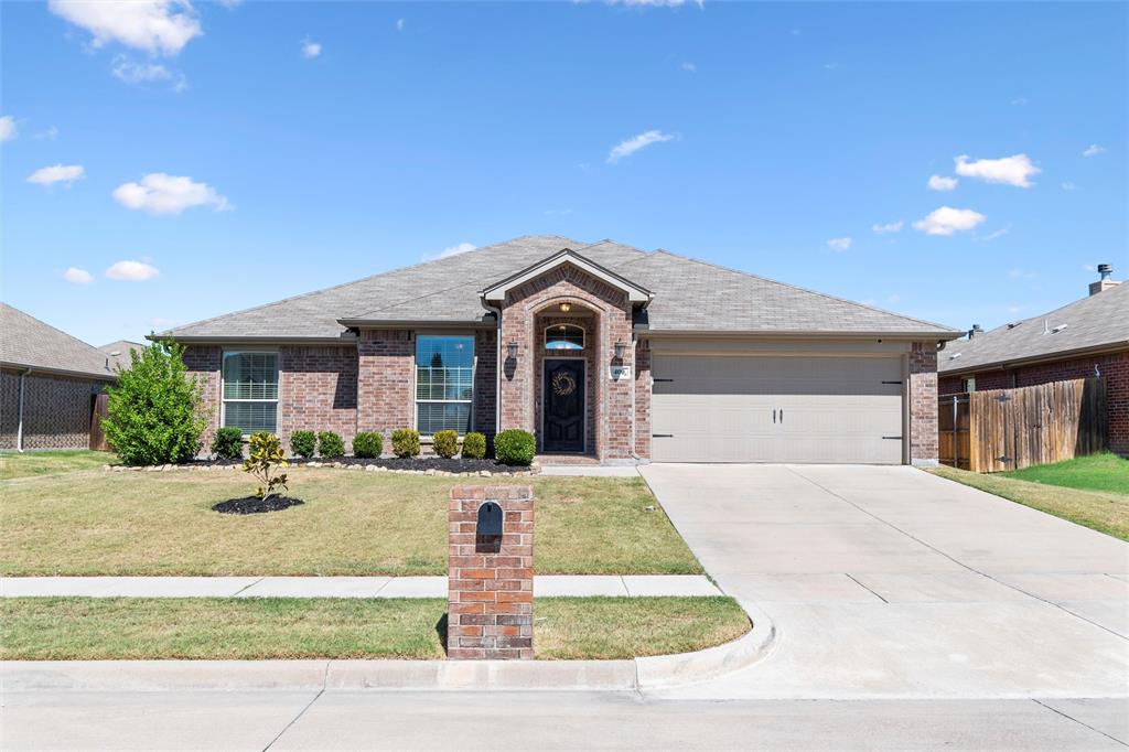 a front view of a house with yard