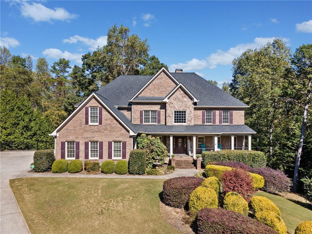 a front view of a house with yard porch and furniture