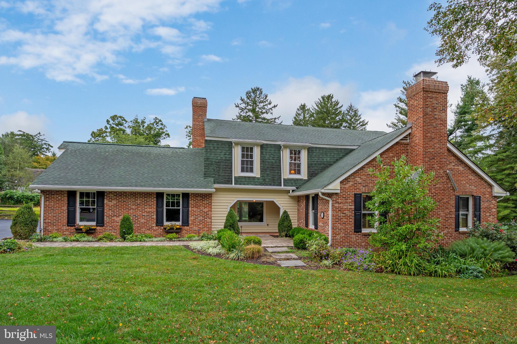 a front view of a house with a garden