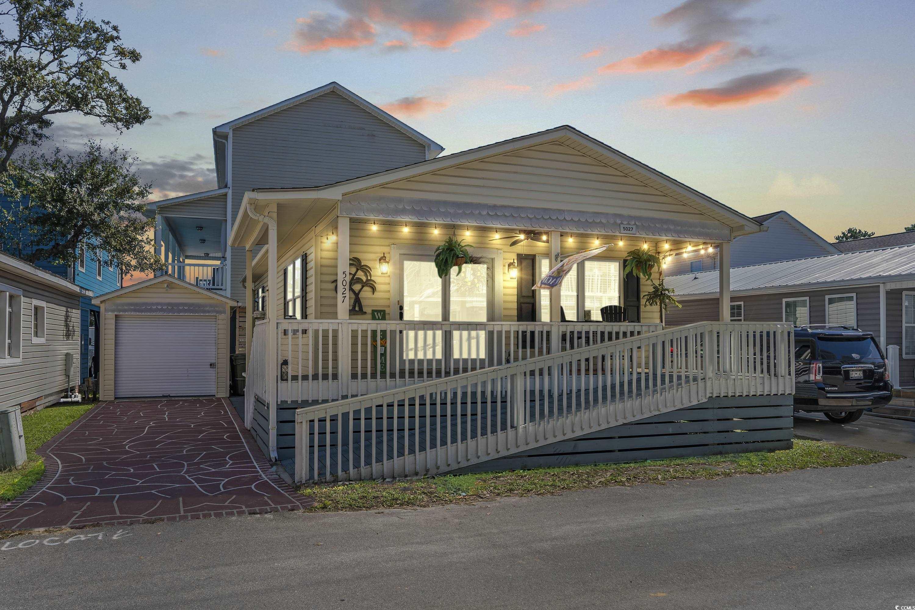 View of front of house featuring a garage, covered