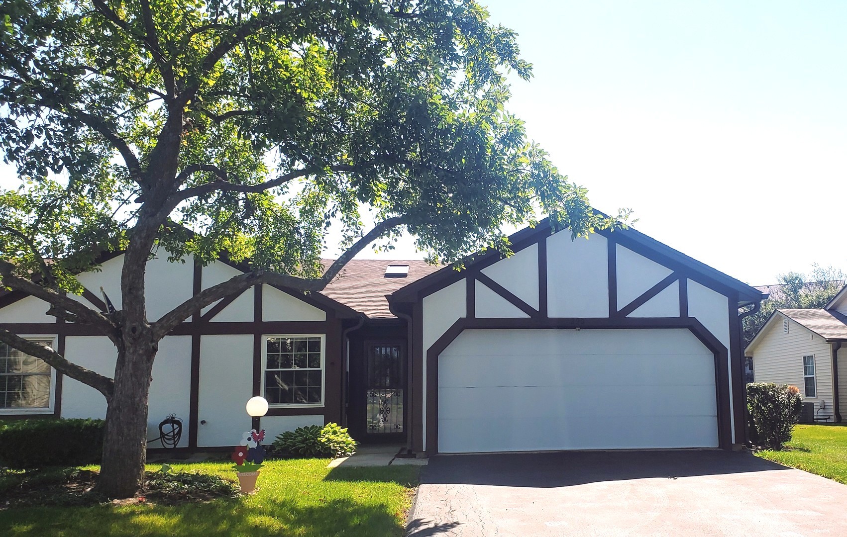 a view of a house with a large tree