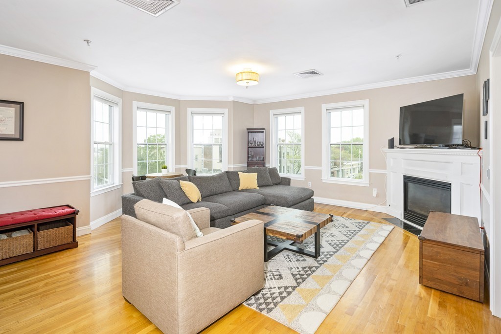 a living room with fireplace furniture and a flat screen tv