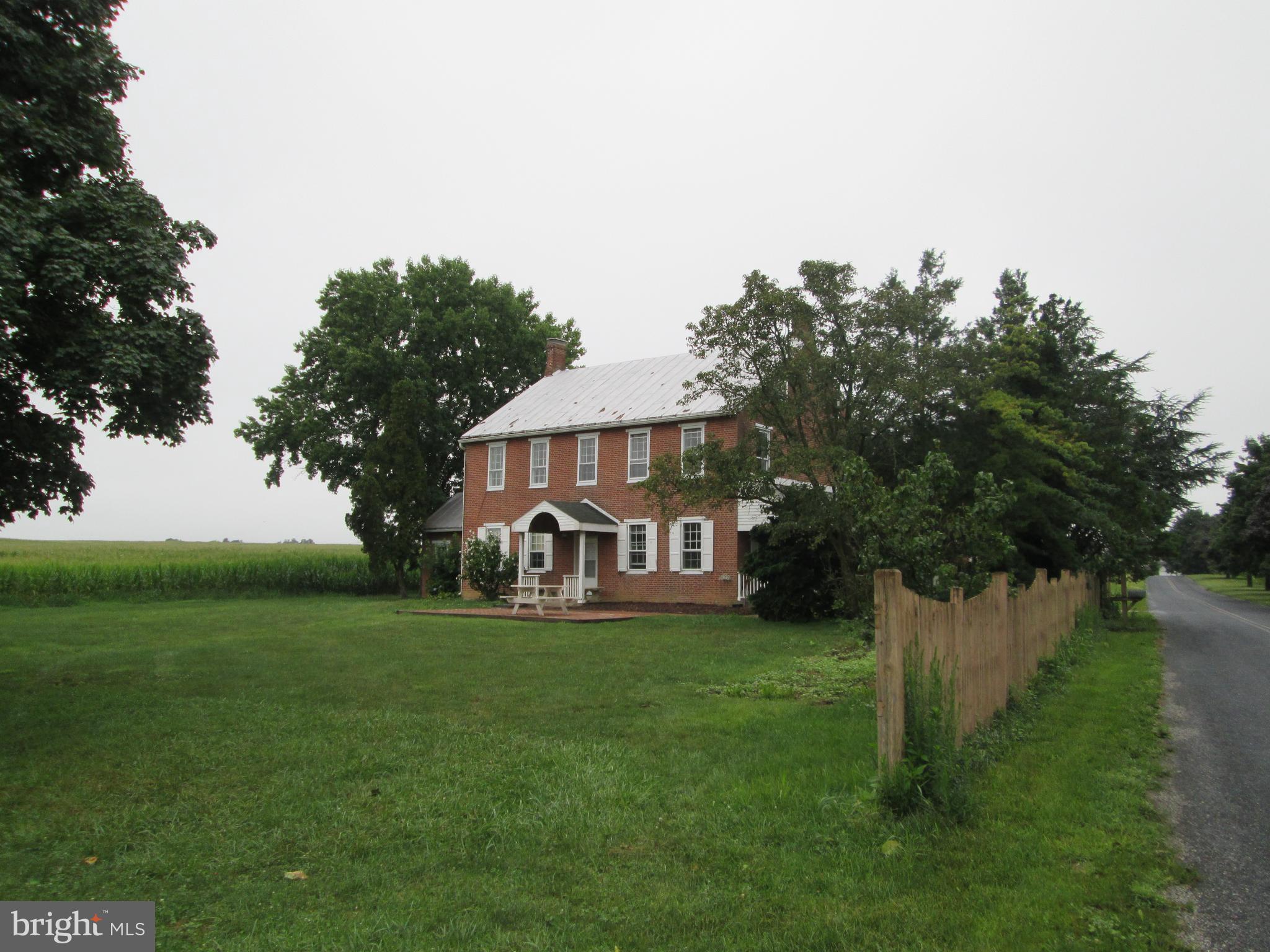 a view of a house with garden and trees