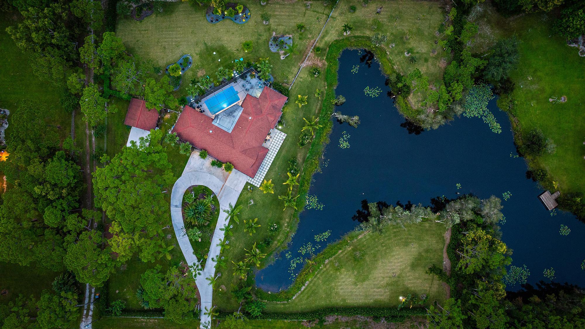 an aerial view of a house with garden space sitting space and swimming pool