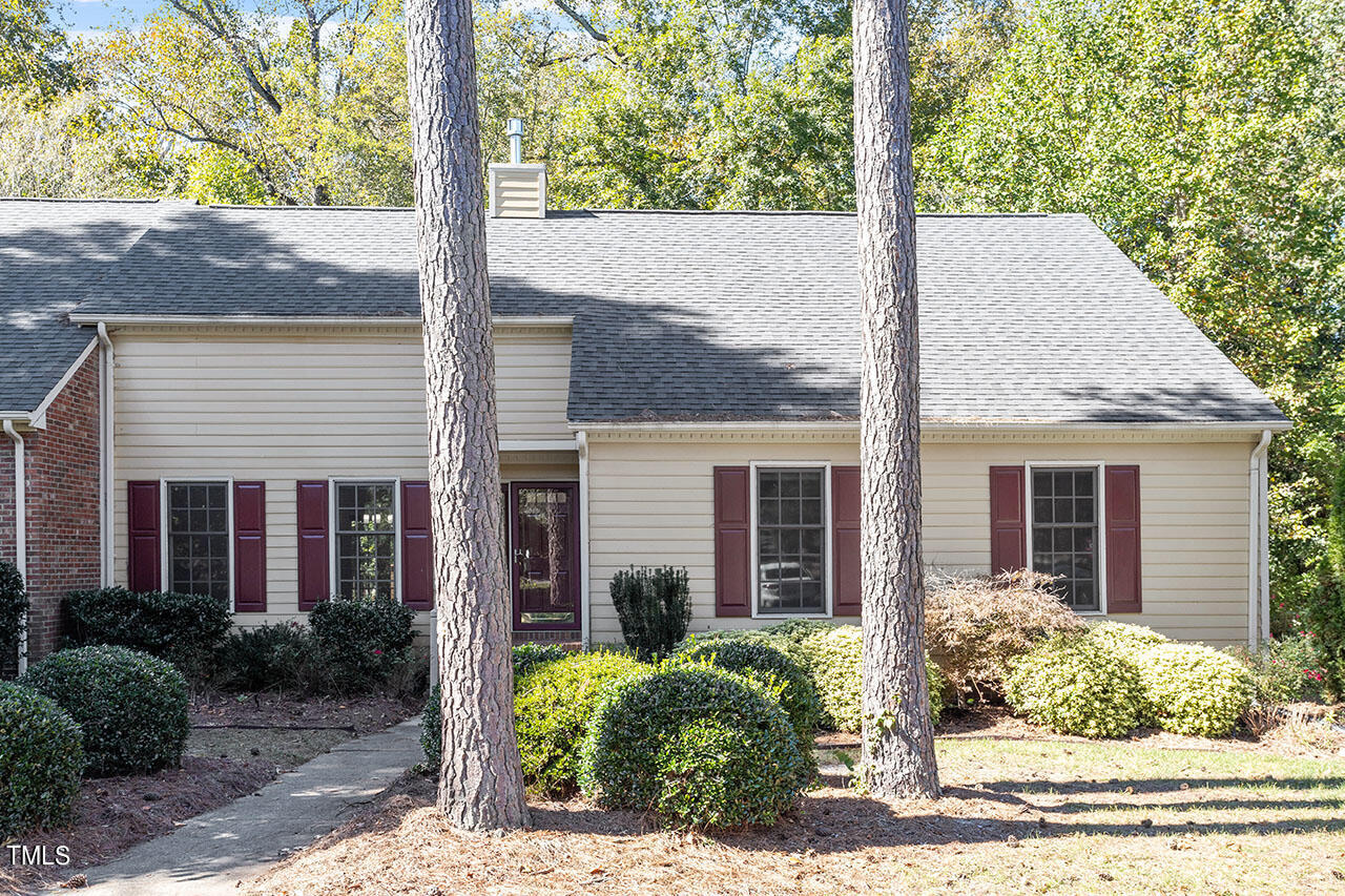 a view of a house with a tree in front of it