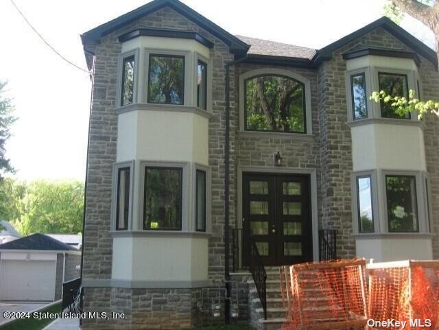 a front view of a house with glass windows