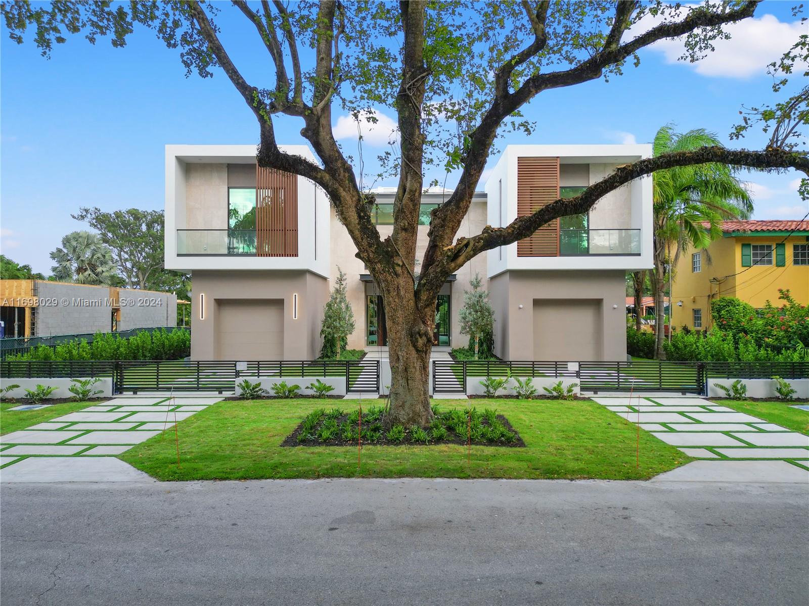 a front view of house with yard and green space