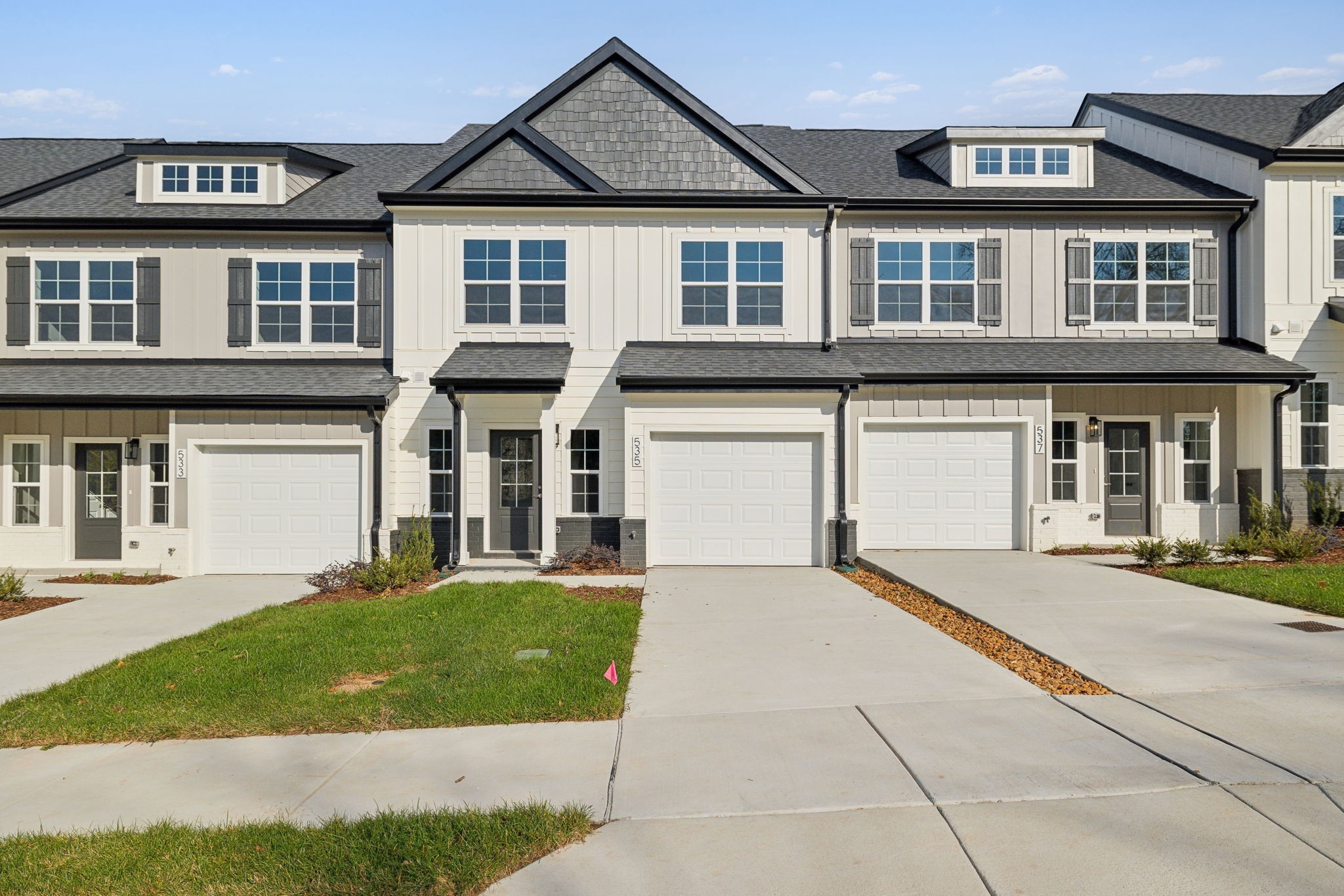 a front view of a house with a yard and garage