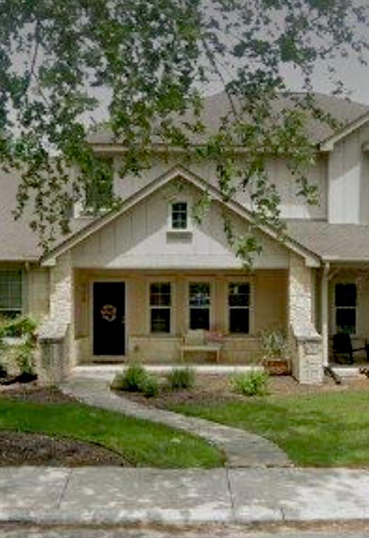 a front view of a house with a yard and a garage