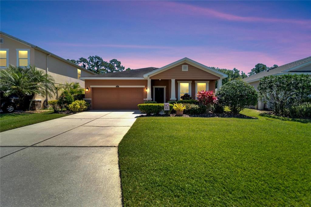 a front view of a house with a yard and garage