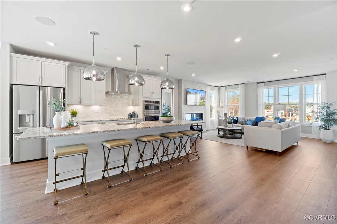 a large kitchen with cabinets a sink a counter space and stainless steel appliances