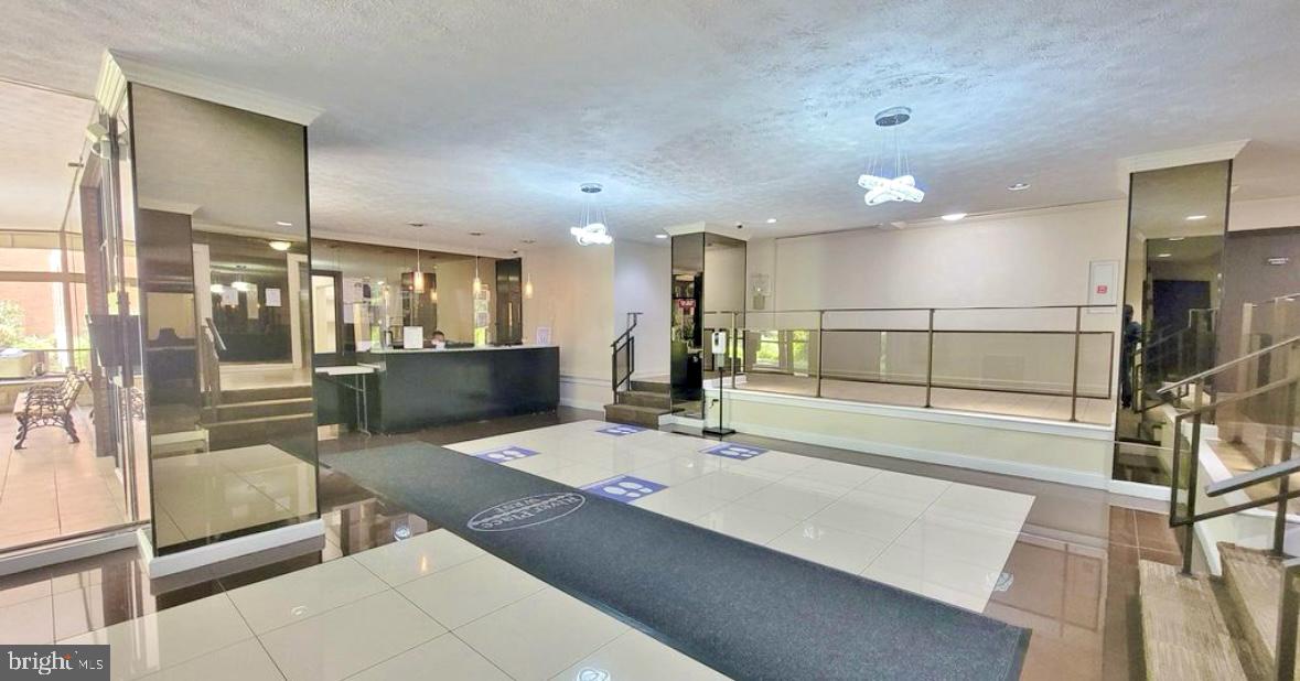 a lobby with a couch and a view of living room