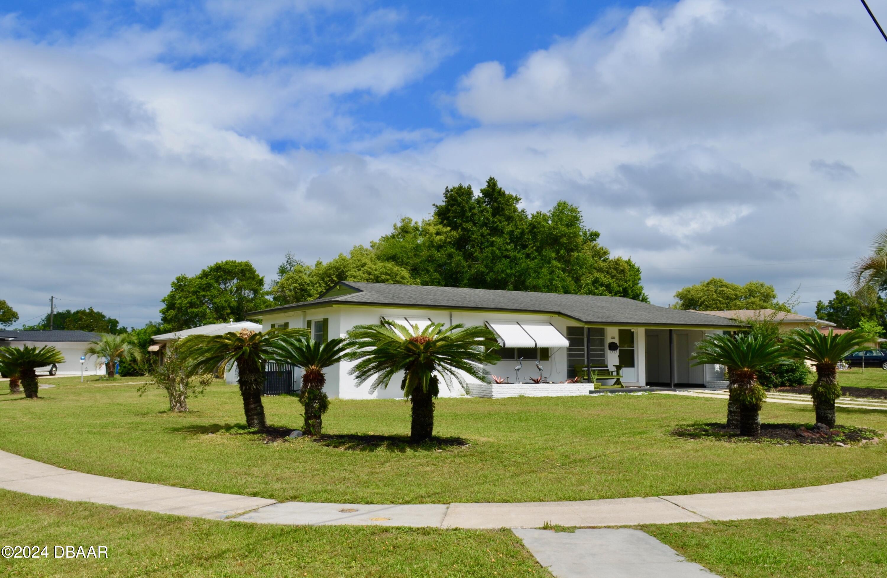 a view of house with a yard