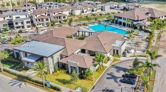 an aerial view of house with yard swimming pool and ocean view