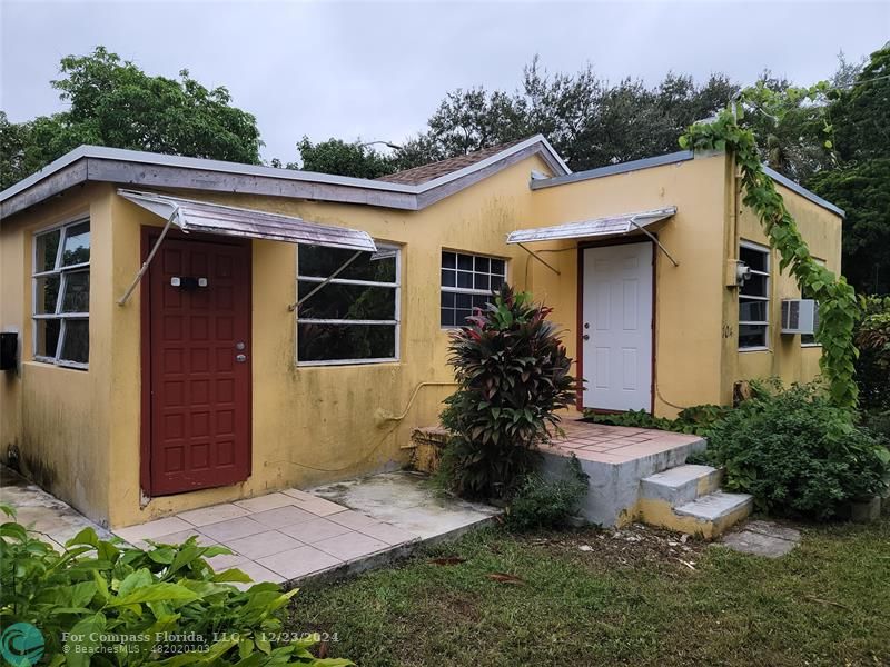 a view of a house with a small yard and plants