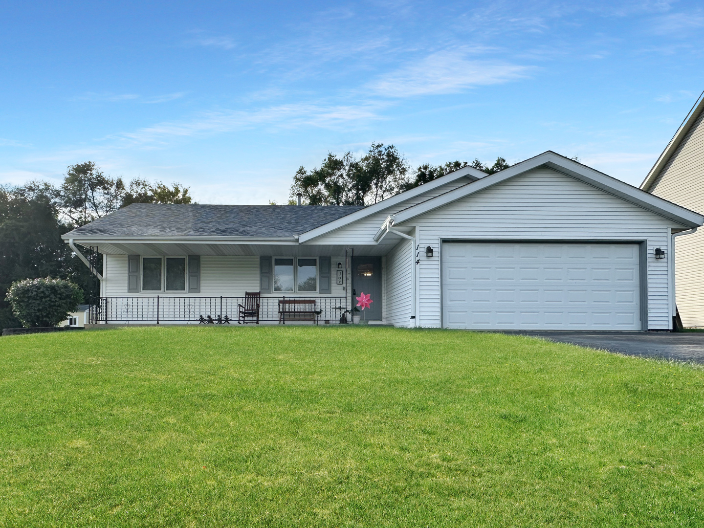 a front view of a house with a garden and deck