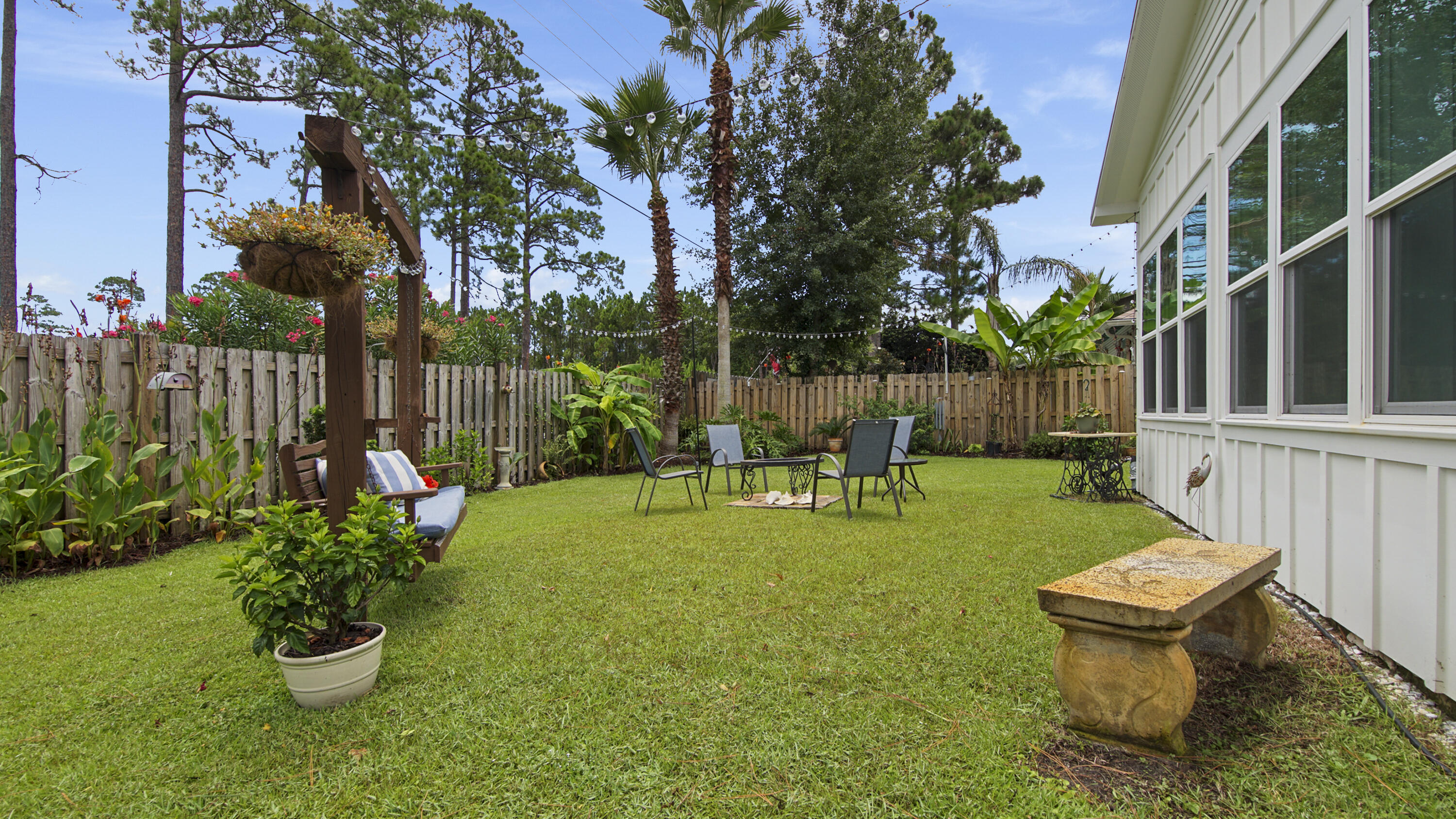 a garden with a bench and some plants