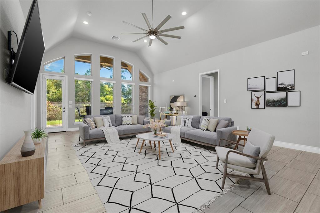 a living room with furniture a flat screen tv and a large window