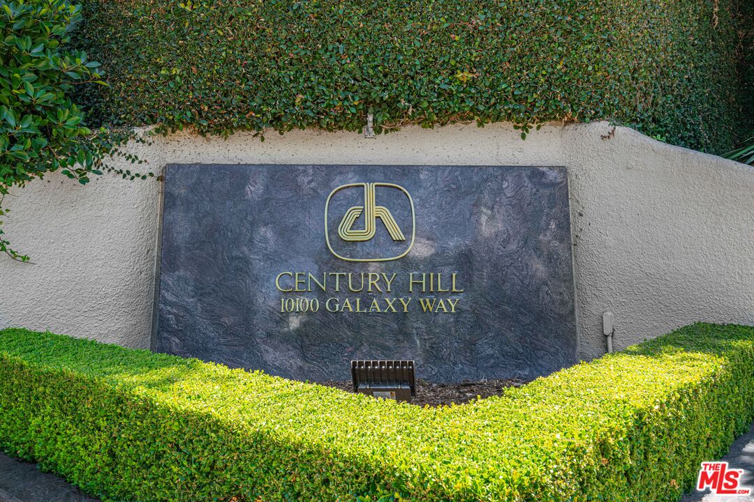 a view of outdoor space with garden and signage