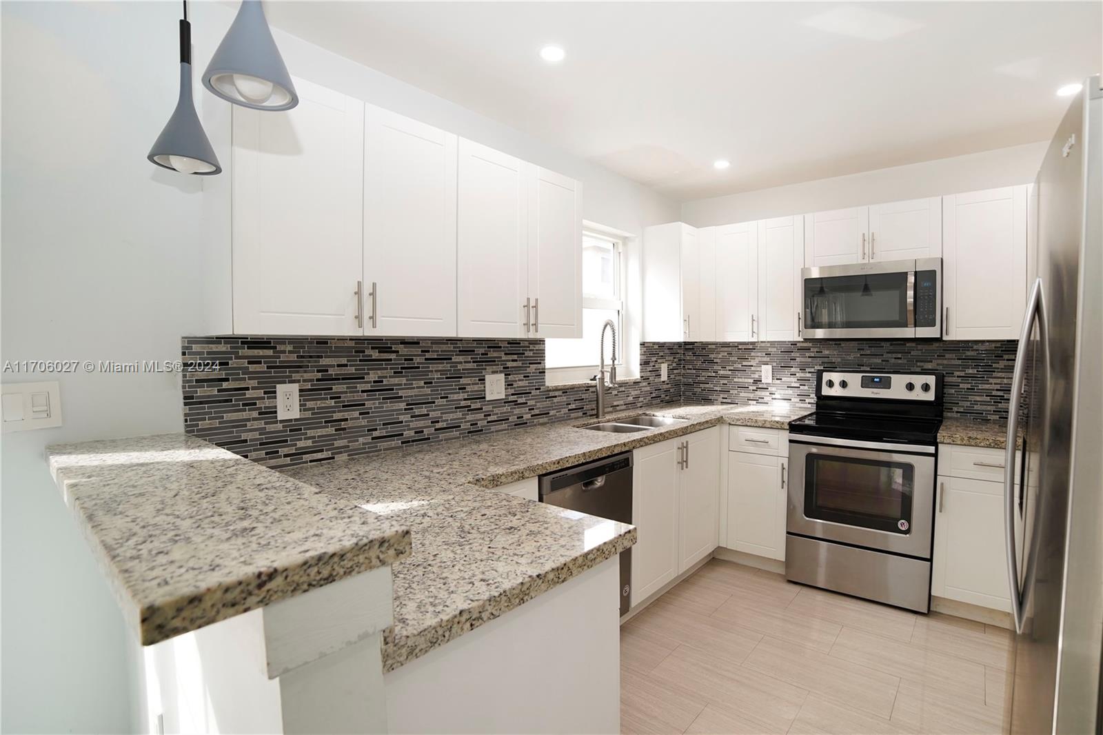 a kitchen with granite countertop a sink and a stove