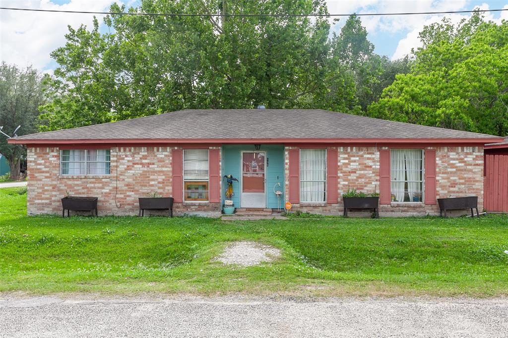 a view of a house with a yard and sitting area