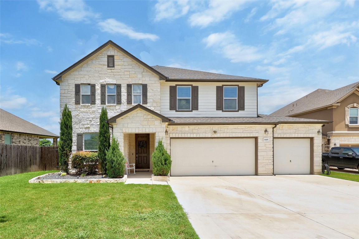 a front view of a house with a yard and garage